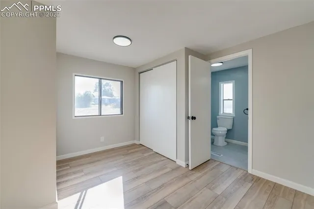 a view of a room with wooden floor and a bathroom