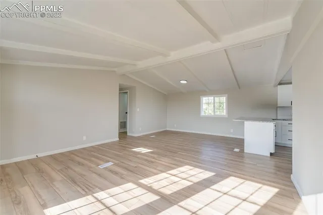 a view of an empty room and a window