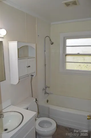 a bathroom with a toilet a sink and bathtub