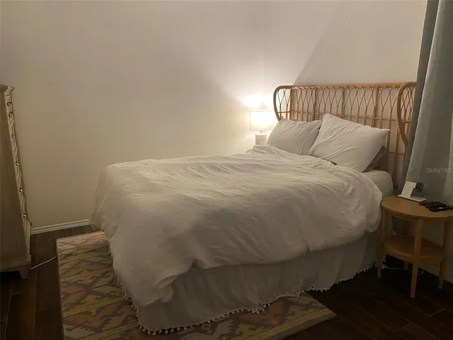 a bedroom with a bed and a night stand