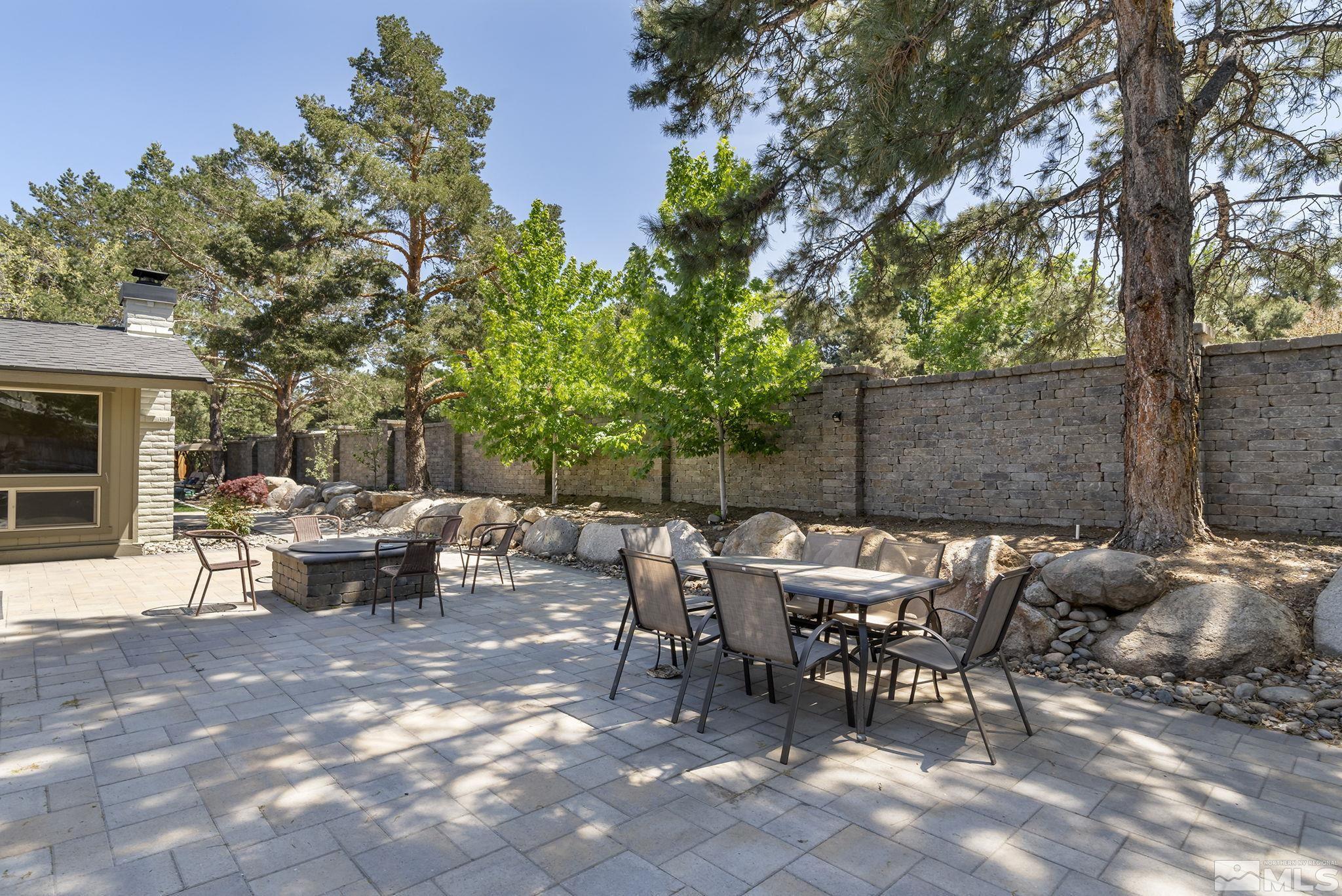 1490 Shewmaker Court Reno, NV 89509 - Photo 29 of 40 a view of a patio with table and chairs and potted plants