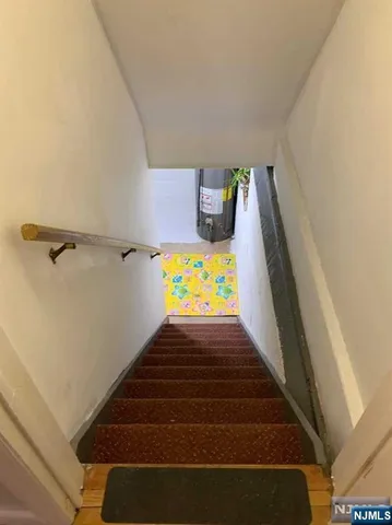 an entryway with wooden floor and stairs