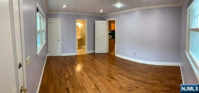 a view of hallway with wooden floor
