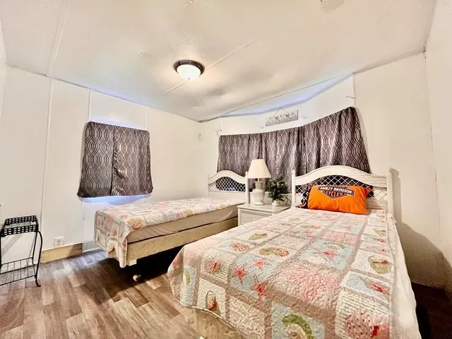 a bedroom with a bed and a view of kitchen