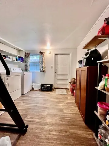 a bedroom with a bed and a view of kitchen