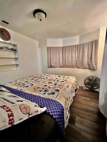 a bedroom with furniture and a mirror