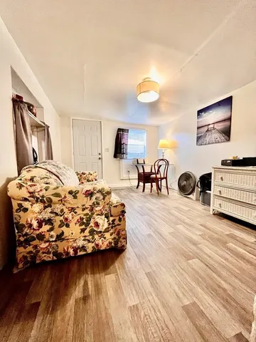 an aerial view of city and lake with trees all around