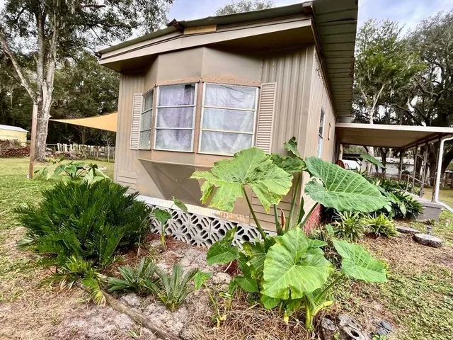 a view of a patio with table and chairs with wooden fence