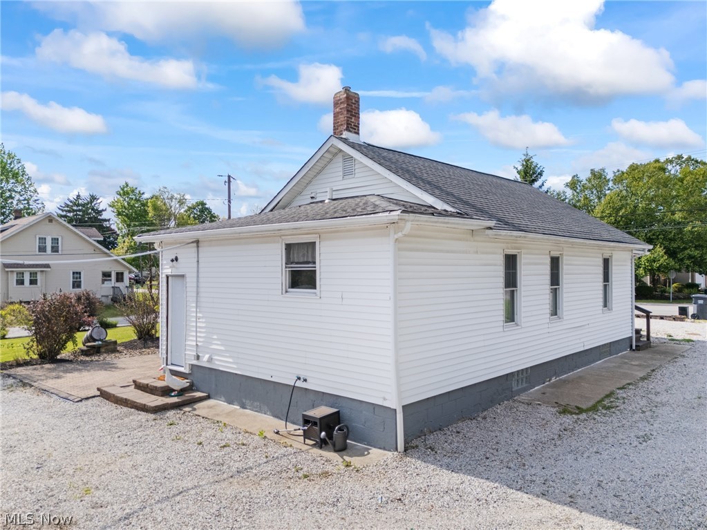 258 Randolph Road Mogadore, OH 44260 - Photo 38 of 49 White siding exterior featuring a dark gray foundation and a shingle roof