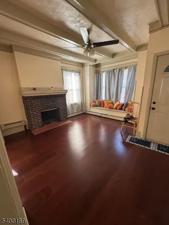 a view of a room with wooden floor window and fireplace