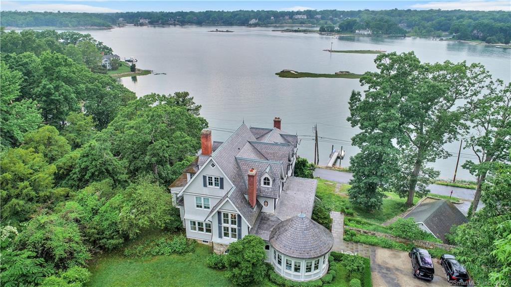 an aerial view of a house with outdoor space and lake view