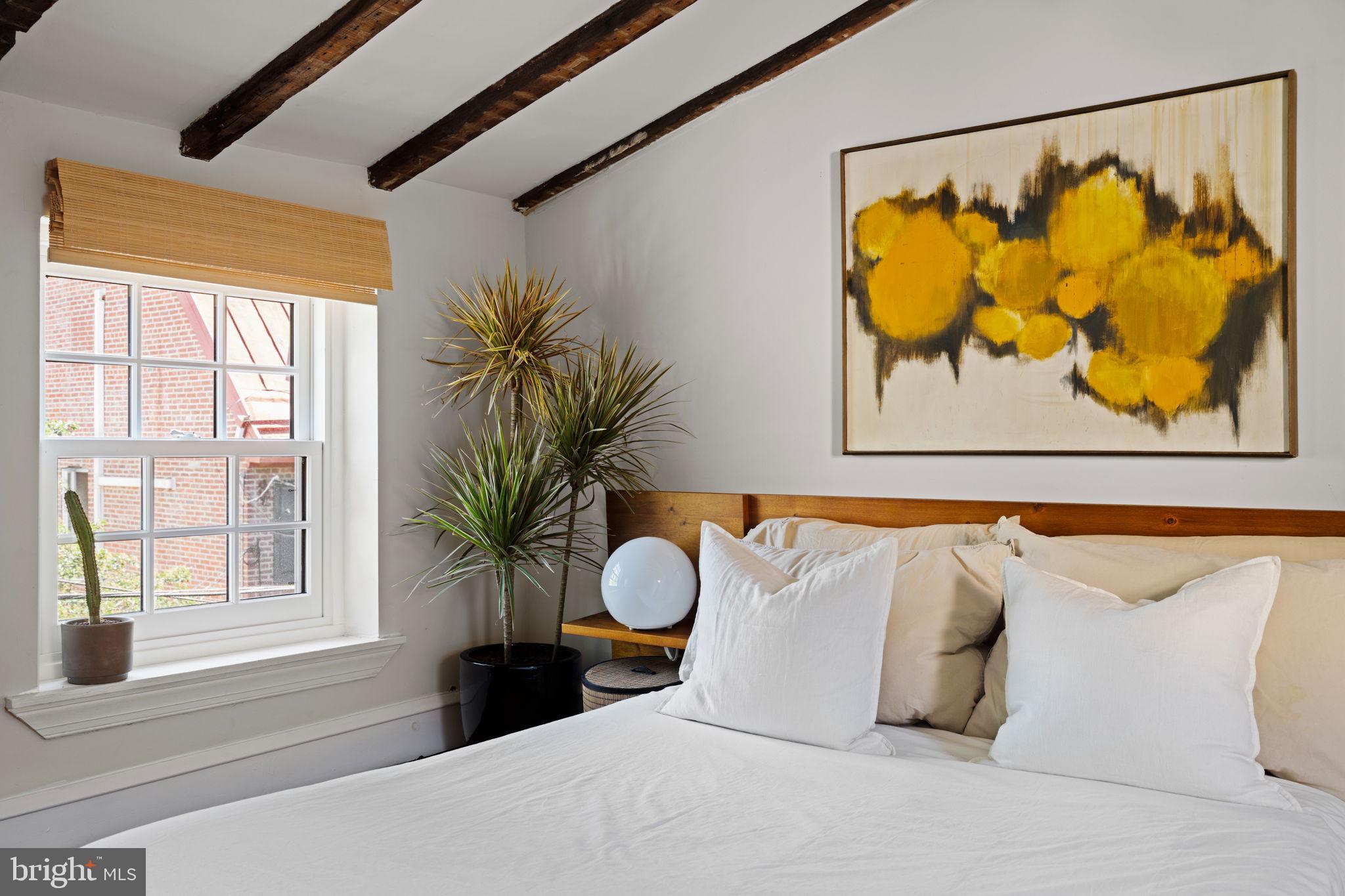 142 Carpenter Street Philadelphia, PA 19147 - Photo 40 of 49 a bedroom with a bed painting on wall and a large window