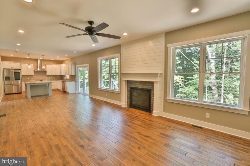 3209 Wrangle Hill Road Bear, DE 19701 - Photo 6 of 7 an open kitchen view with fireplace and wooden floor