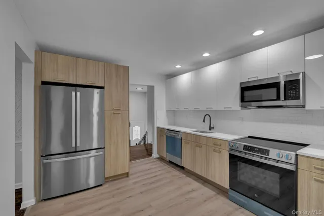 a kitchen with stainless steel appliances a refrigerator stove and microwave