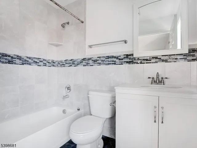 a bathroom with a sink a toilet and bathtub