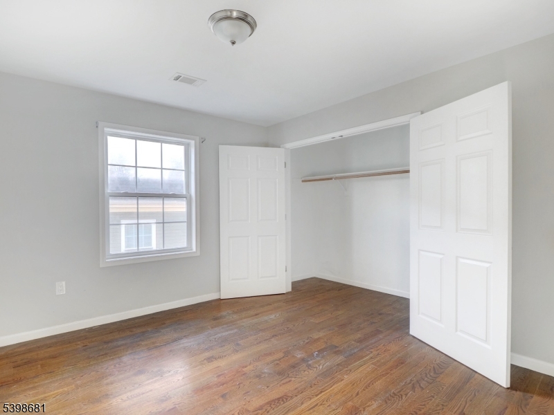521 Walnut Street, Unit 2 Elizabeth, NJ 07201 - Photo 9 of 13 an empty room with wooden floor and windows