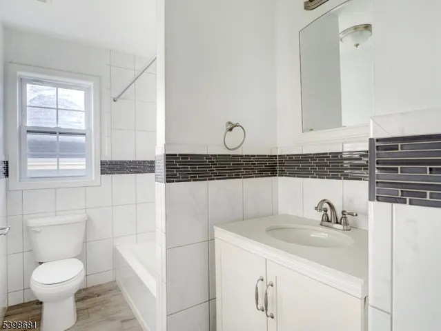 a bathroom with a sink toilet and vanity