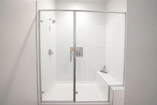 a bathroom with a bathtub and a shower