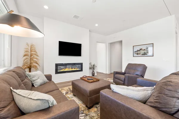 a living room with a bed furniture and a window