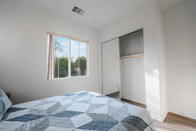 a bedroom with a bed and a window