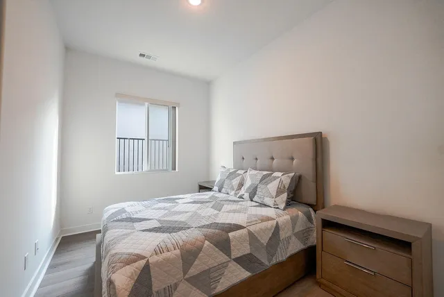 a bedroom with a bed and window