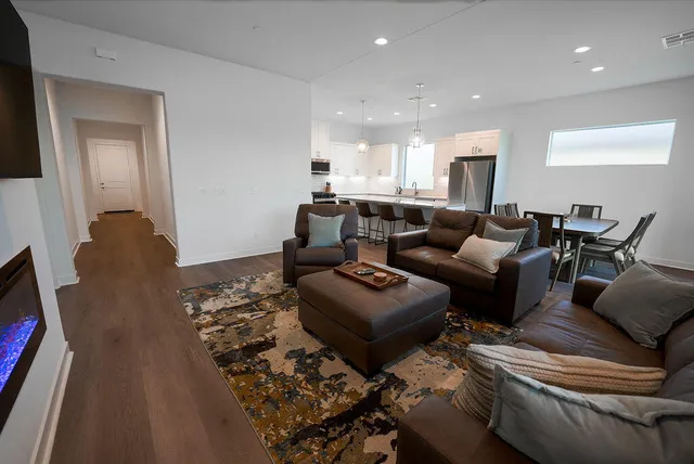 a living room with furniture and wooden floor