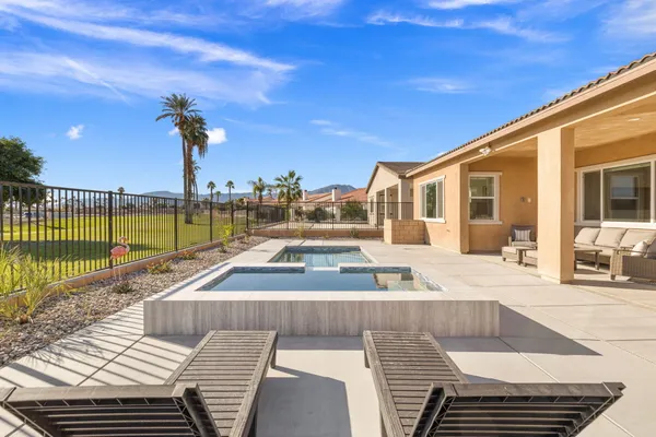 a view of a swimming pool with a lounge chairs