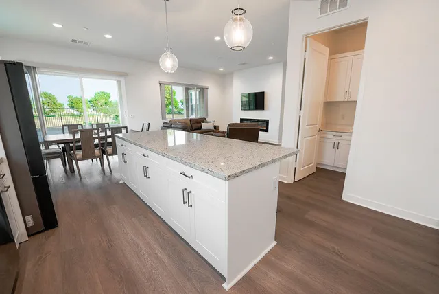 a large white kitchen with a large window