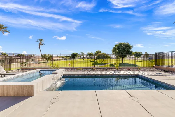 a view of a house with swimming pool and sitting area