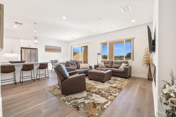 a kitchen with granite countertop cabinets stainless steel appliances and wooden floor
