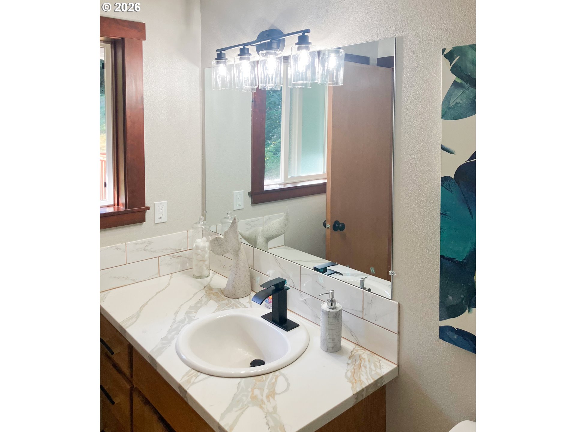 650 Marvin Road Tillamook, OR 97141 - Photo 27 of 48 a bathroom with a sink and a mirror