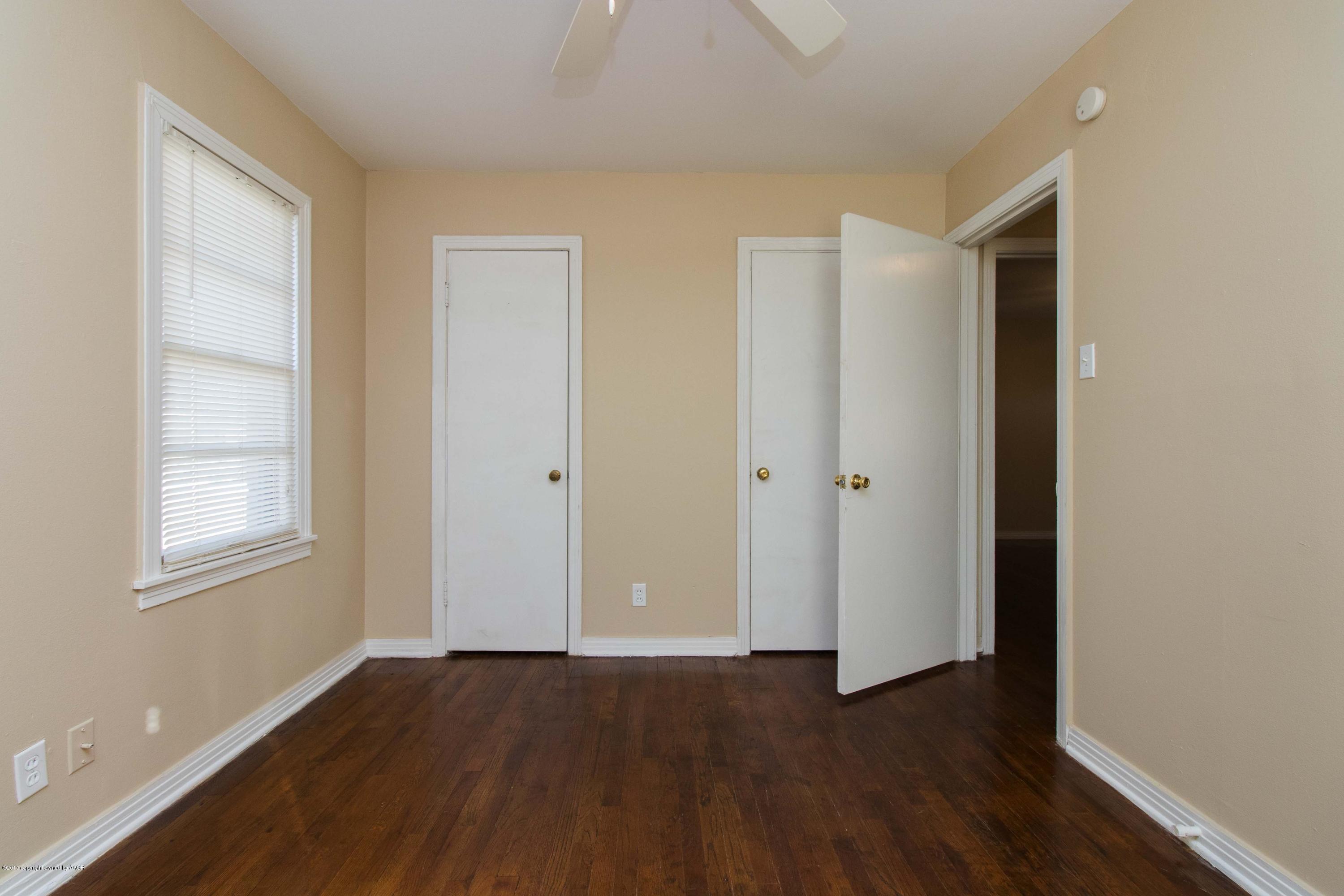 4314 Parker Street Amarillo, TX 79110 - Photo 12 of 20 an empty room with wooden floor and windows
