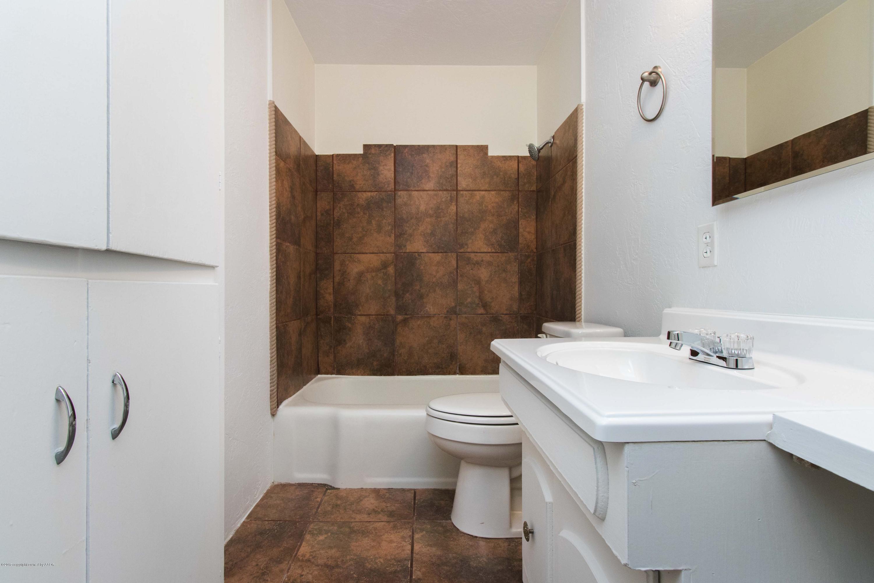 4314 Parker Street Amarillo, TX 79110 - Photo 15 of 20 a bathroom with a sink toilet and shower