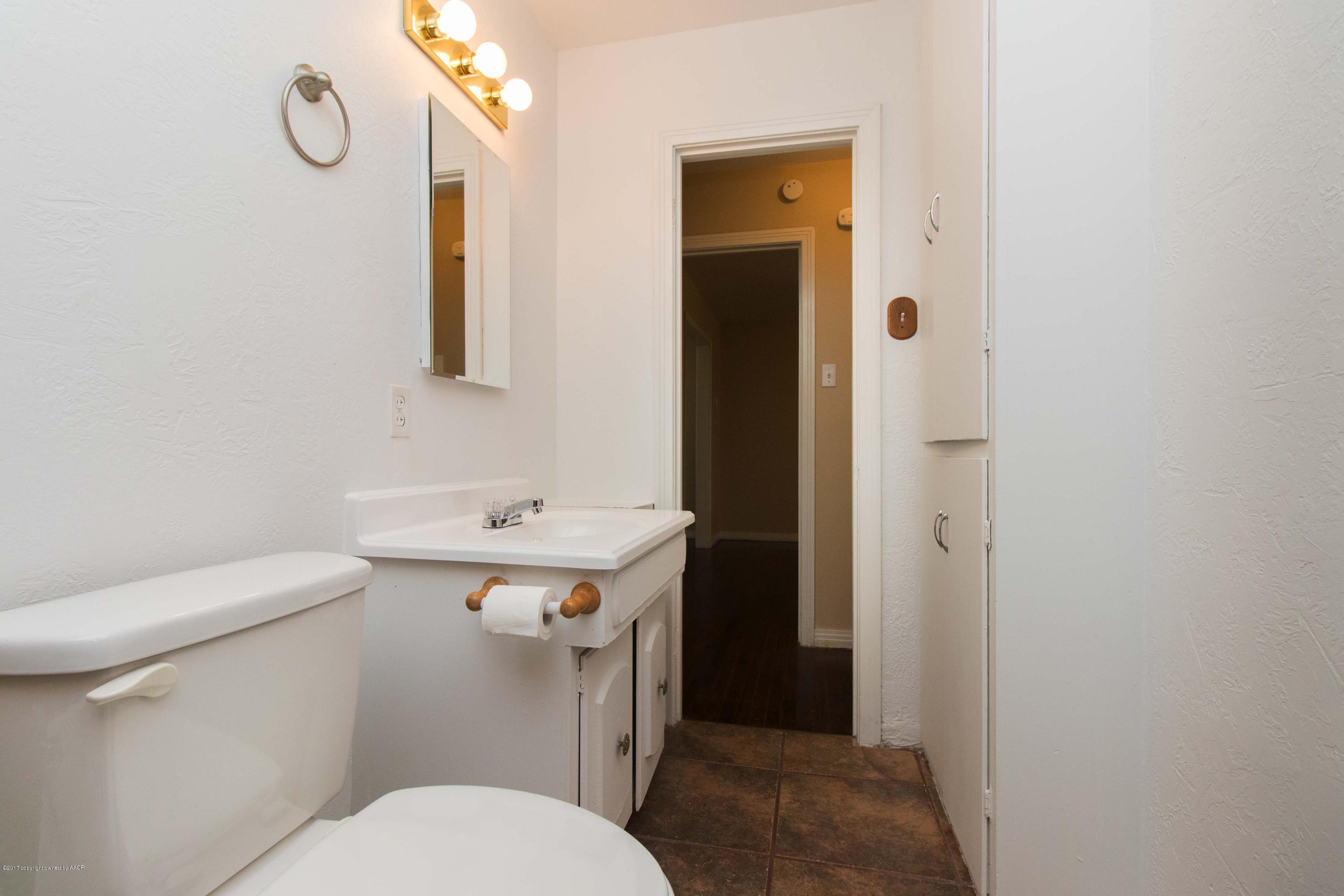4314 Parker Street Amarillo, TX 79110 - Photo 16 of 20 a bathroom with a sink a toilet and shower