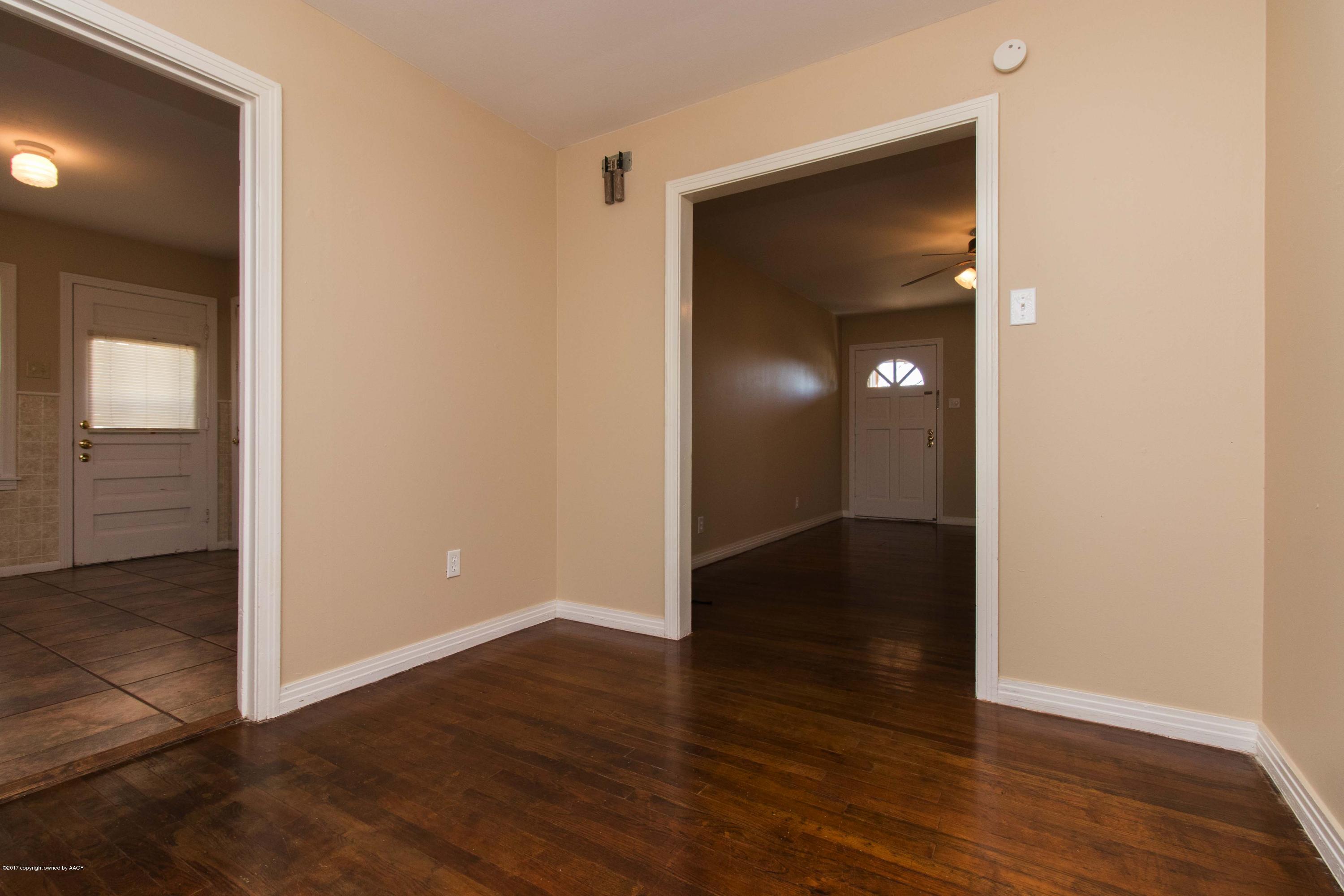 4314 Parker Street Amarillo, TX 79110 - Photo 7 of 20 an empty room with wooden floor & closet