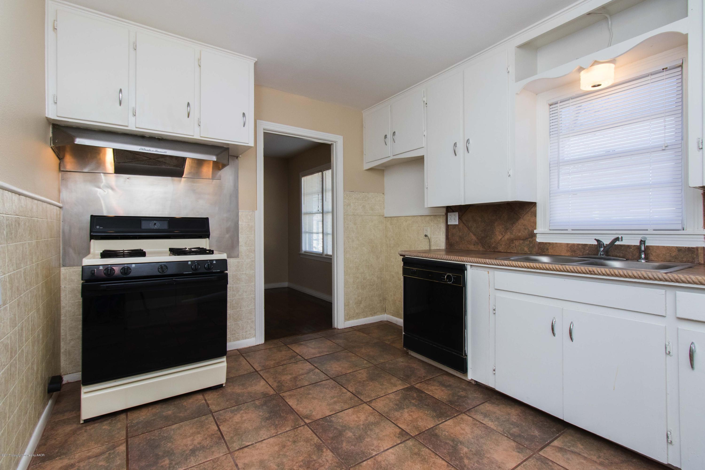 4314 Parker Street Amarillo, TX 79110 - Photo 9 of 20 a kitchen with stainless steel appliances granite countertop a refrigerator and a stove