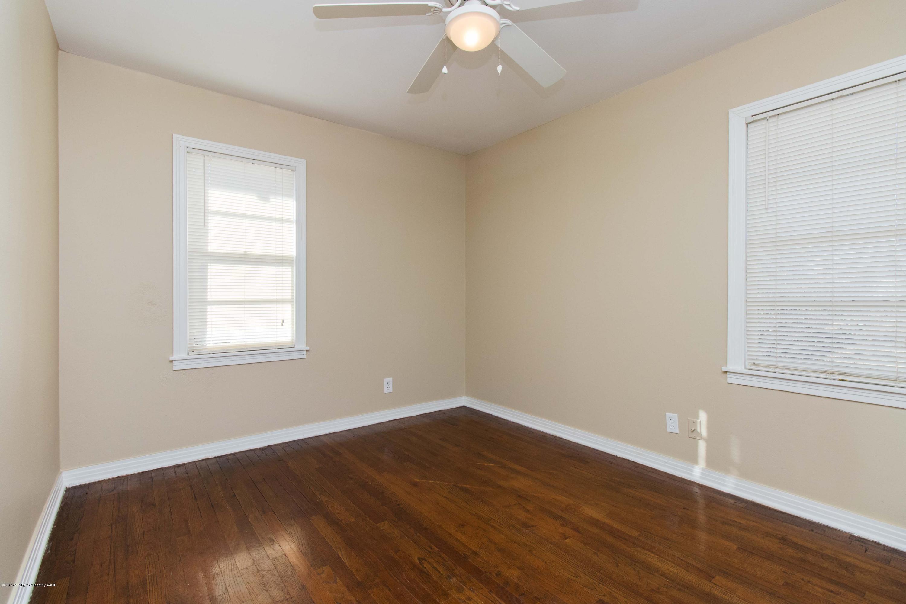 4314 Parker Street Amarillo, TX 79110 - Photo 10 of 20 wooden floor in an empty room with a window