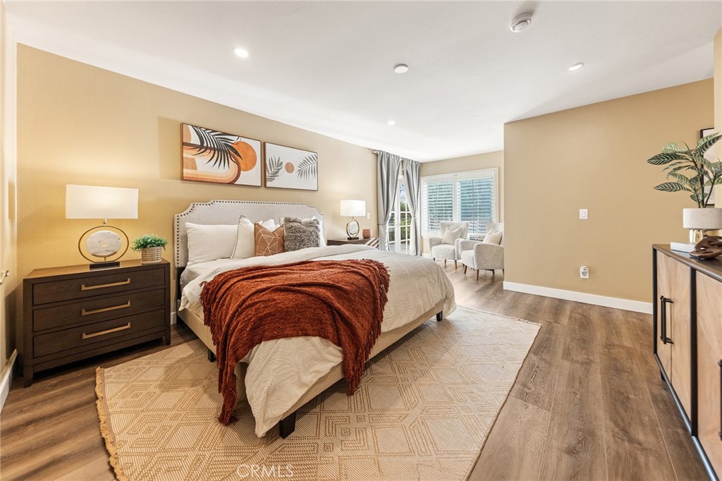 6296 Marble Avenue Rancho Cucamonga, CA 91701 - Photo 45 of 89 a bedroom with a bed and a chandelier