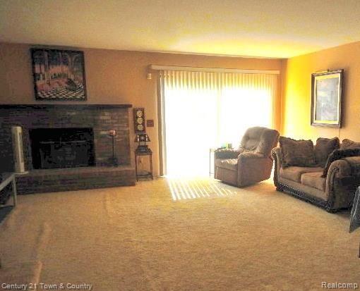 684 Tennyson, Unit 9 Rochester, MI 48307 - Photo 5 of 26 Family Room with doorwall to deck and Gas fireplace