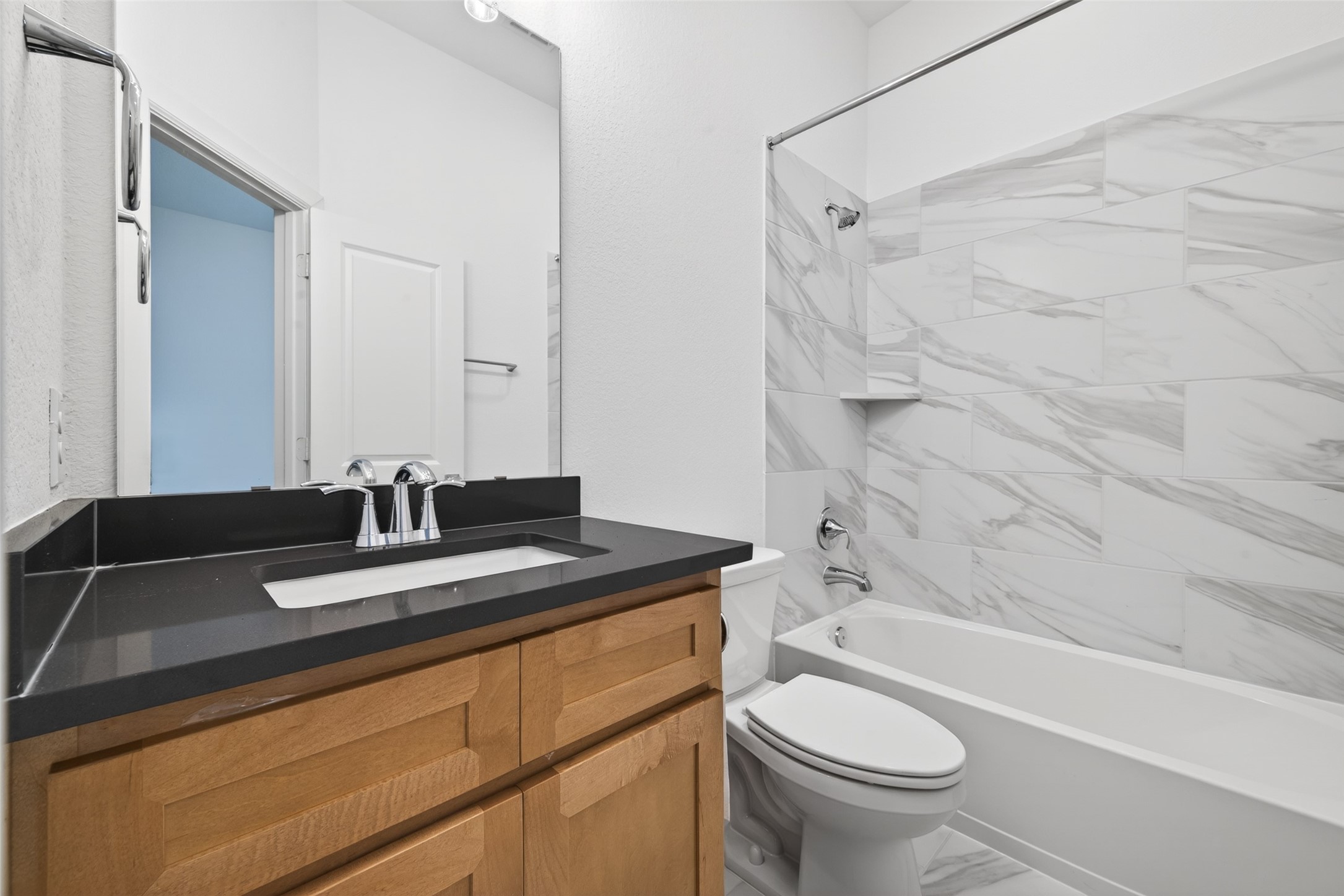 211 Amaranth Way Richmond, TX 77406 - Photo 9 of 26 a bathroom with a granite countertop sink toilet a mirror and shower