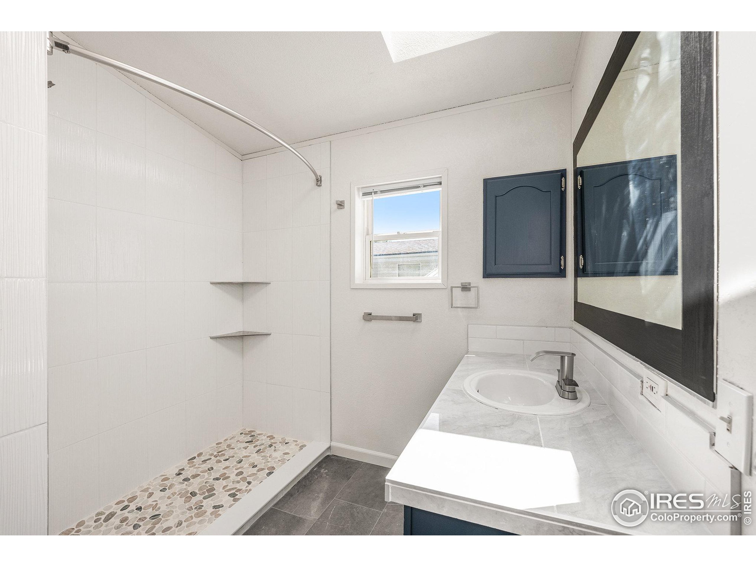 230 North 2nd Street, Unit 26 Berthoud, CO 80513 - Photo 13 of 21 a bathroom with a sink and a mirror