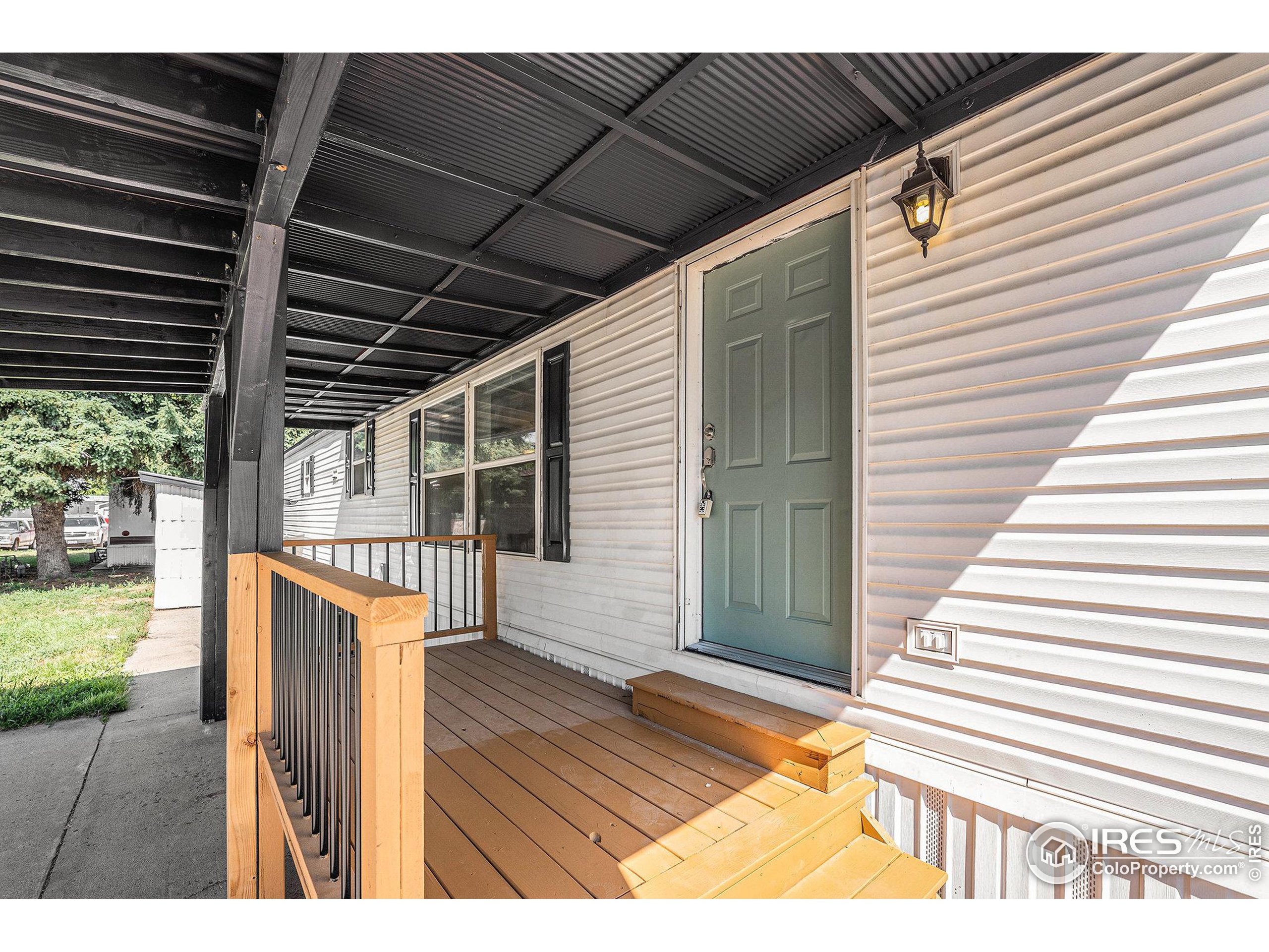 230 North 2nd Street, Unit 26 Berthoud, CO 80513 - Photo 3 of 21 a view of a backyard with wooden floor and fence