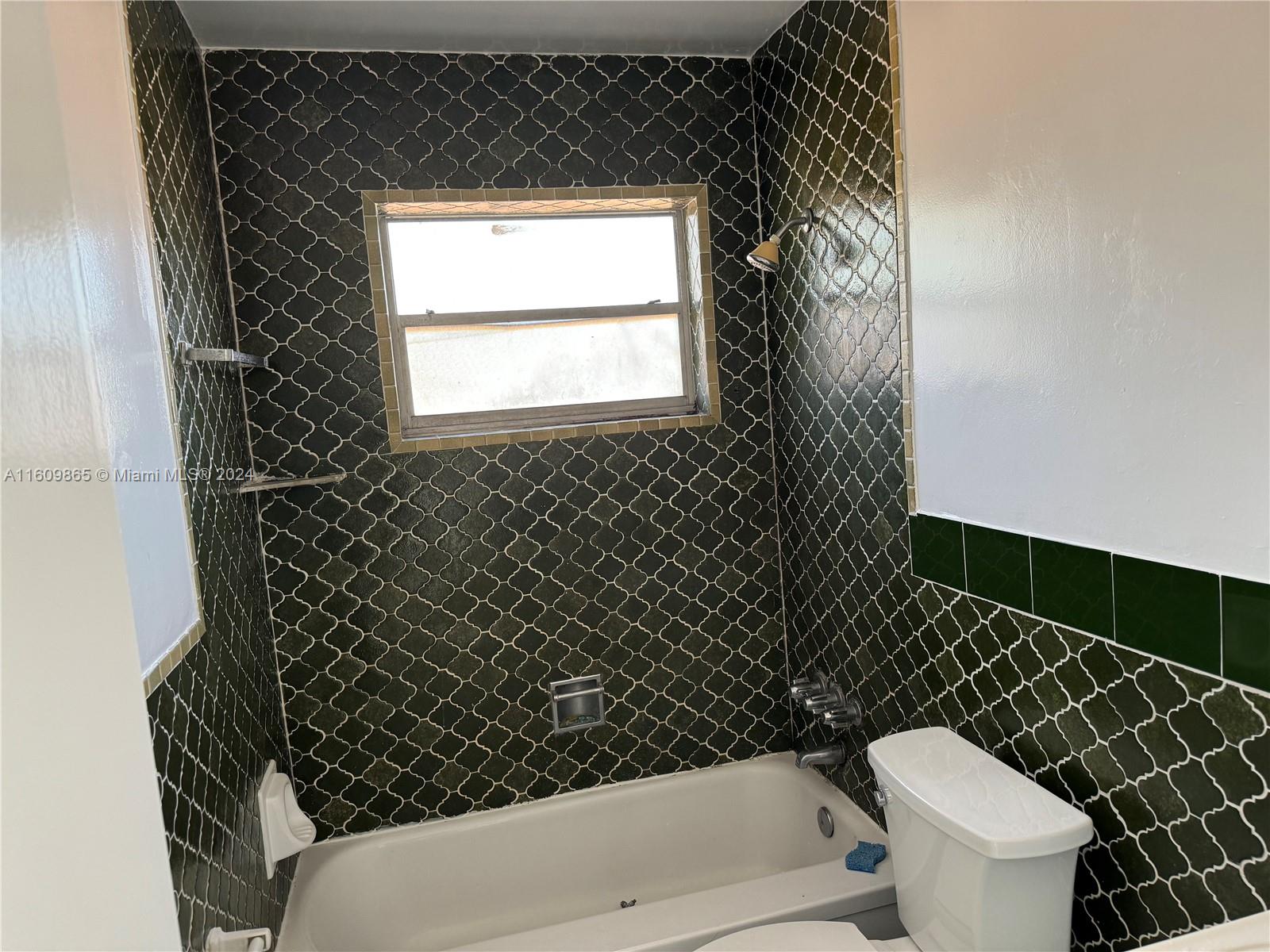 2008 Pierce Street, Unit 3 Hollywood, FL 33020 - Photo 4 of 9 a bathroom with a toilet a sink and a window