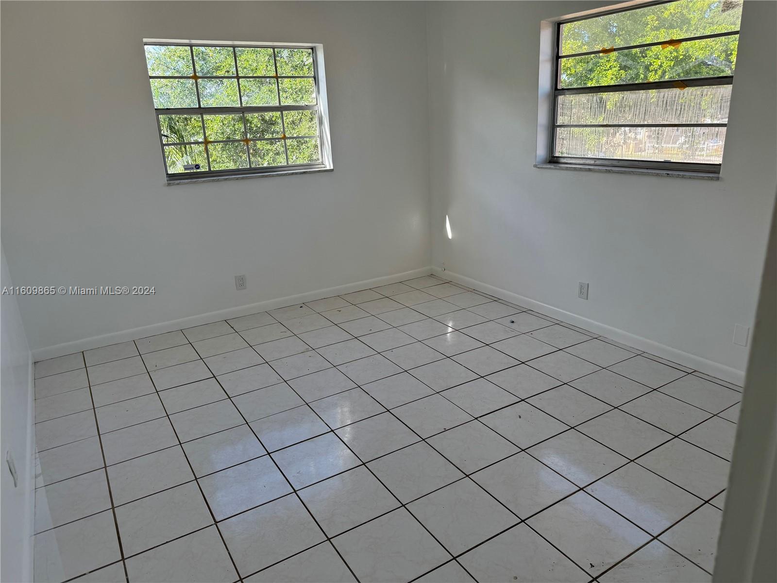 2008 Pierce Street, Unit 3 Hollywood, FL 33020 - Photo 7 of 9 an empty room with windows