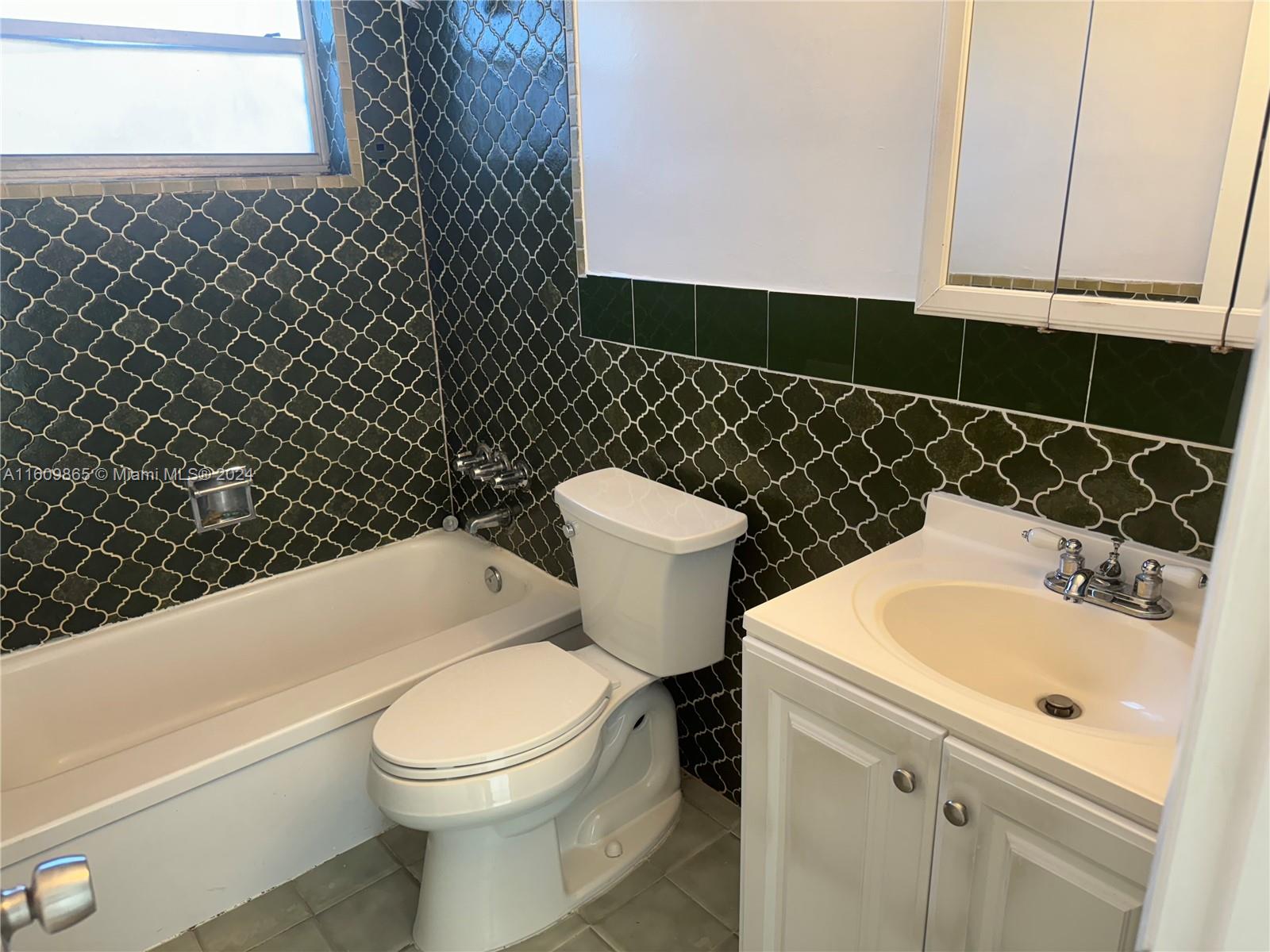 2008 Pierce Street, Unit 3 Hollywood, FL 33020 - Photo 8 of 9 a bathroom with a sink and a toilet