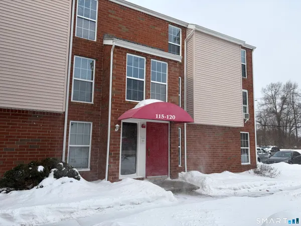 a view of a house with snow on the road