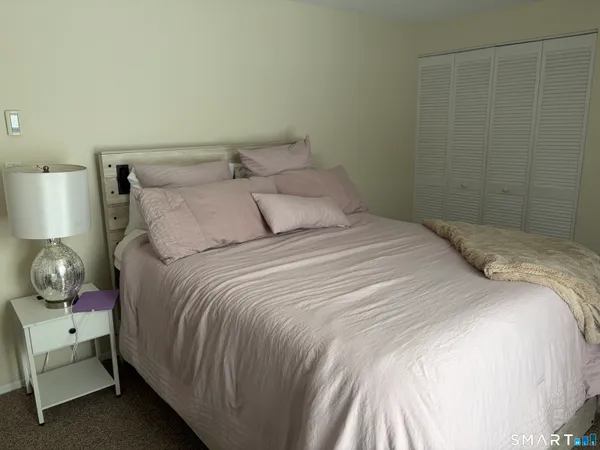 a bedroom with a bed and lamp