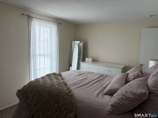 a bed sitting in a bedroom next to a window