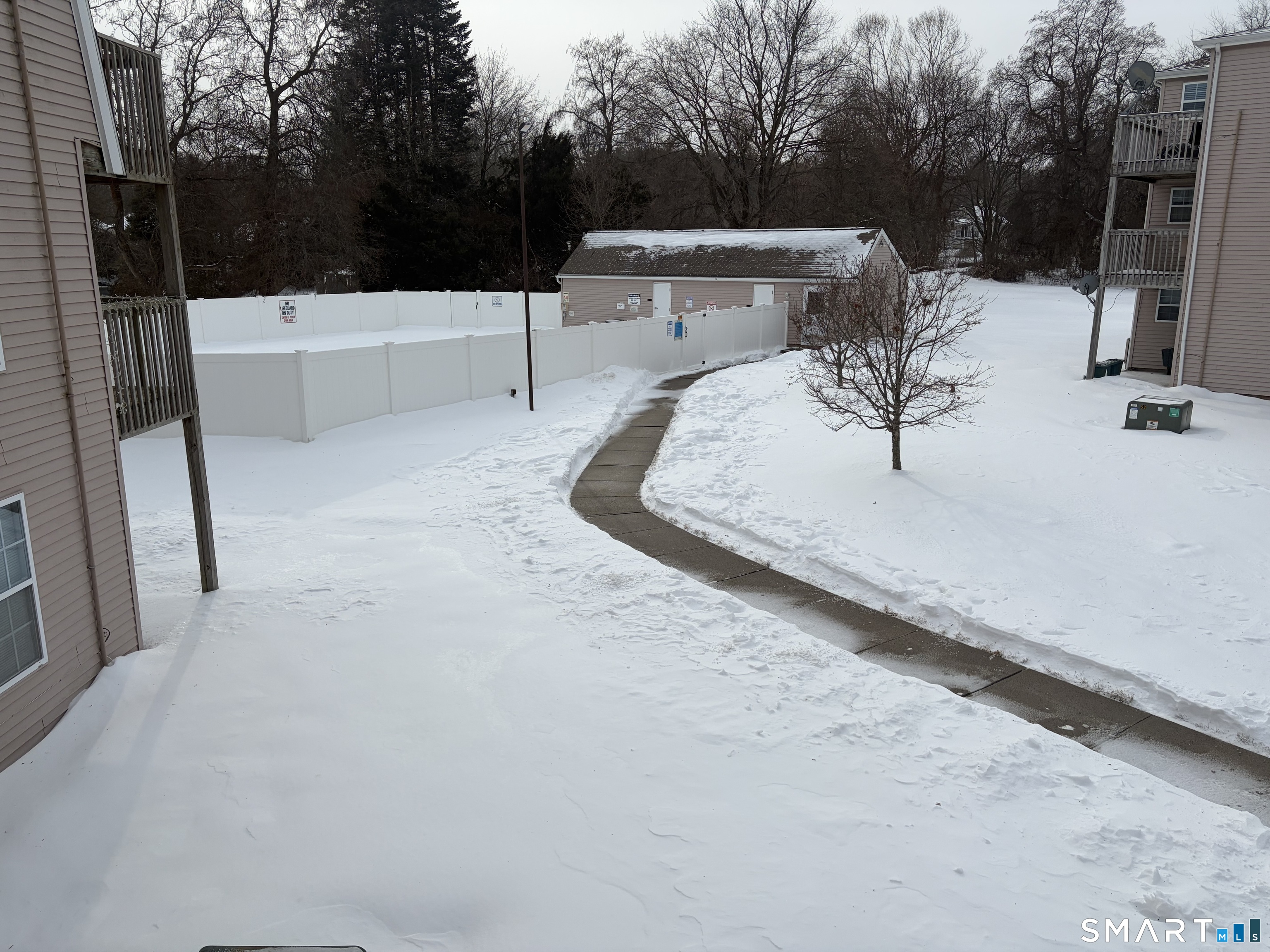 117 Heather Ridge, Unit 117 Shelton, CT 06484 - Photo 5 of 17 View out living room of pool and the small building is the laundry facility