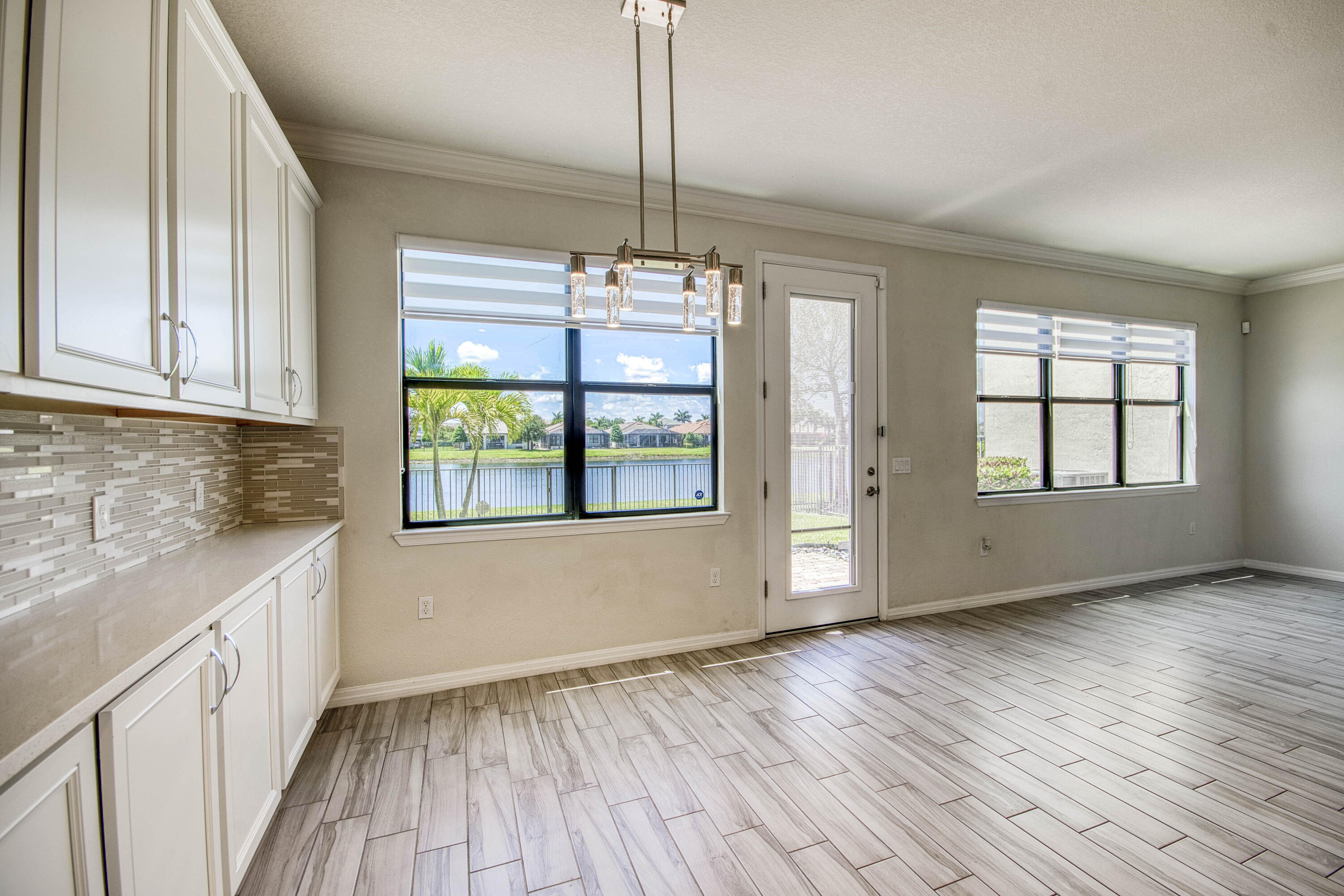 8301 Rearing Lane Lake Worth, FL 33467 - Photo 14 of 33 a view of an empty room with window and wooden floor